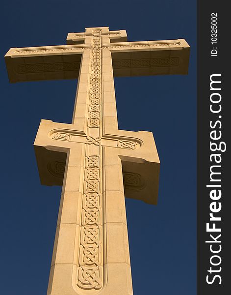 Old cross and sky, yellow limestone, fretwork. Old cross and sky, yellow limestone, fretwork