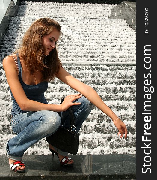 Girl sitting near fountain outdoor