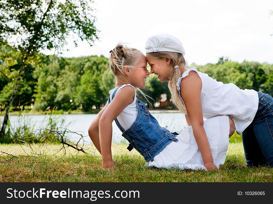 Two little girls in fresh colors in the park. Two little girls in fresh colors in the park