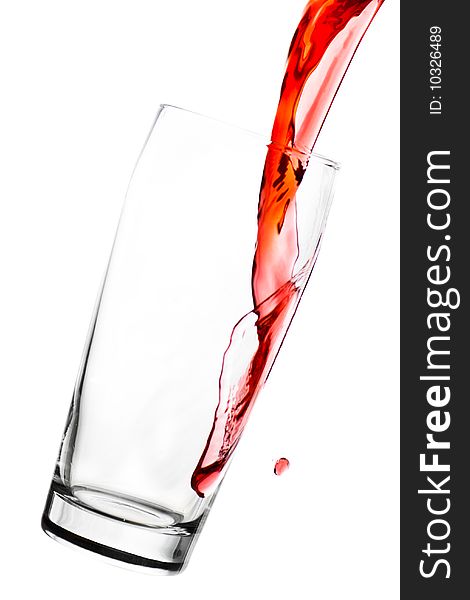 Red juice in glass with splashes - isolated on white