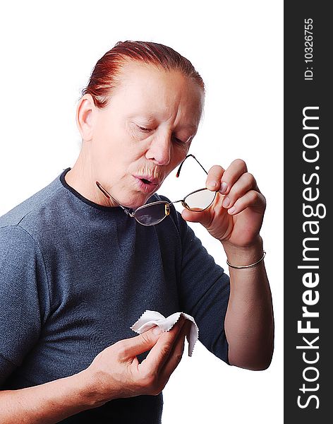 Elderly woman cleaning her glasses