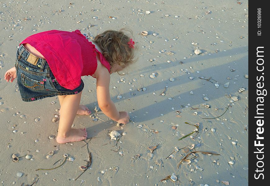 Photo of a little girlalone on the beach. Photo of a little girlalone on the beach