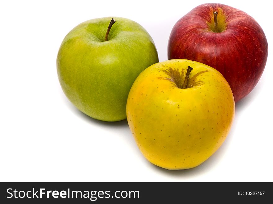 Red, yellow and green fresh apples on studio white