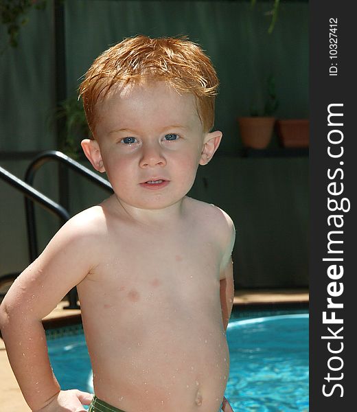 Photo of a redheaded little boy with his hands on his hips. Photo of a redheaded little boy with his hands on his hips