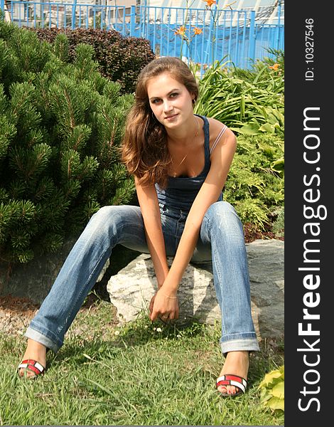 Smiling girl sitting in park