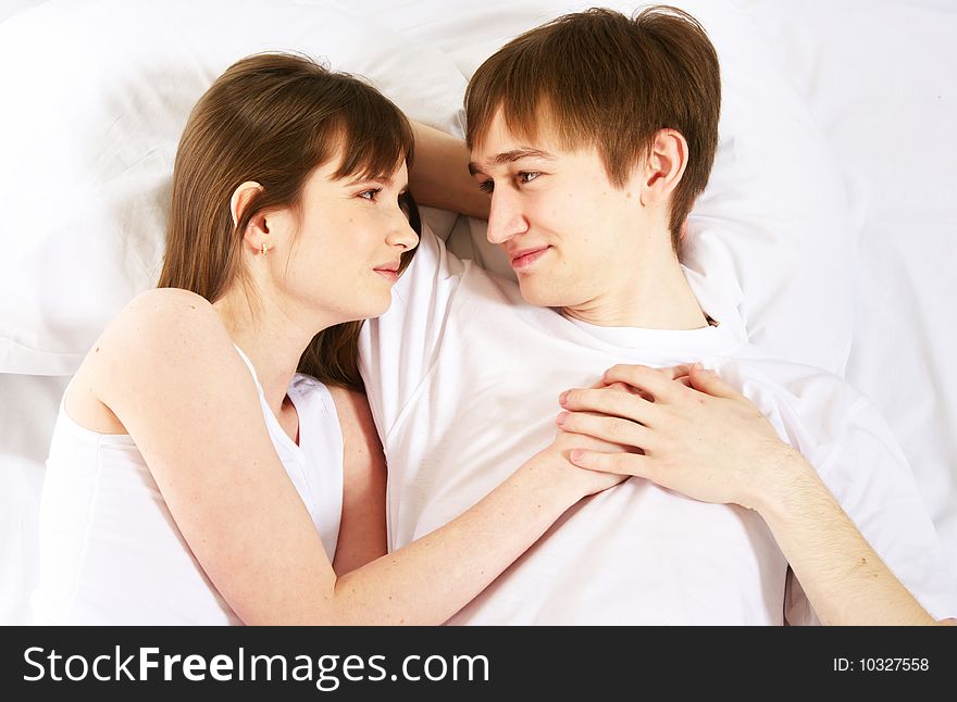 Happy young couple in bed