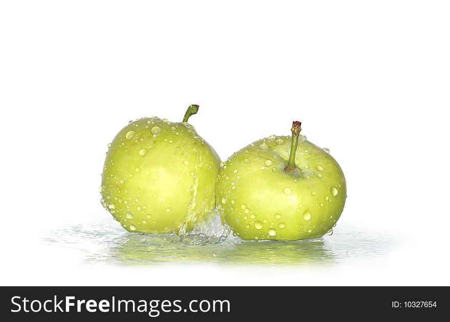 Two fresh green apples under water drops isolated on white background with clipping path
