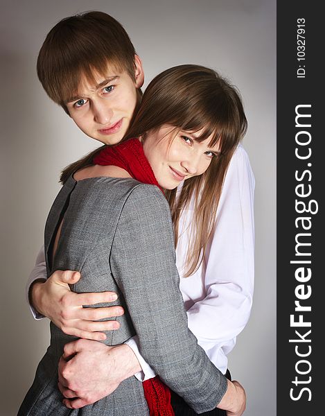 Smiling young couple on gray background. Smiling young couple on gray background