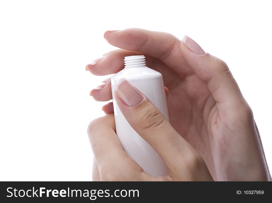 Well-groomed female hand holding a cream tube. Well-groomed female hand holding a cream tube