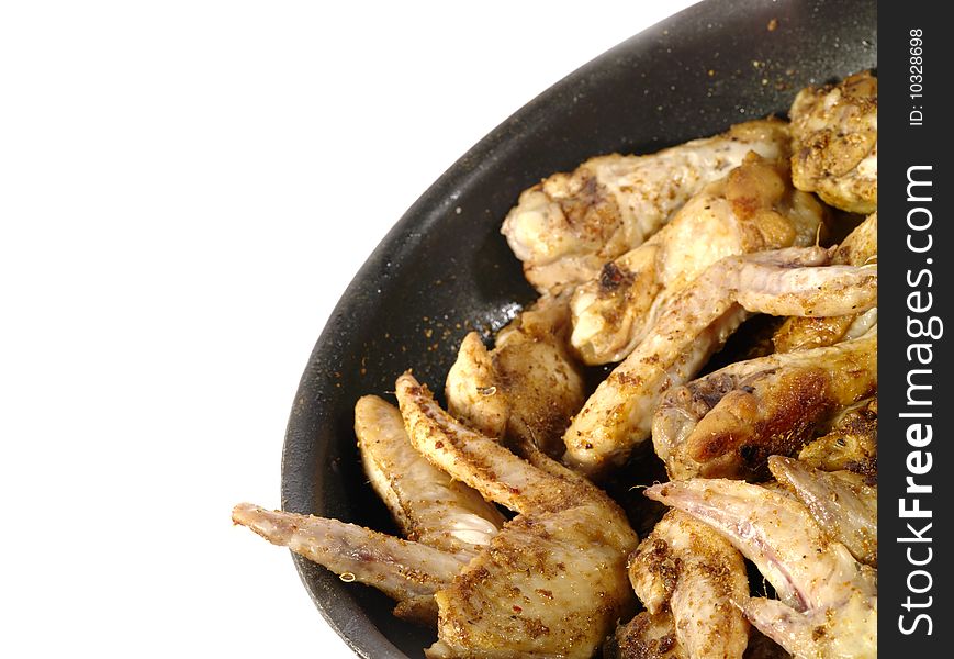 Fried delicious chicken wings on the frying pan