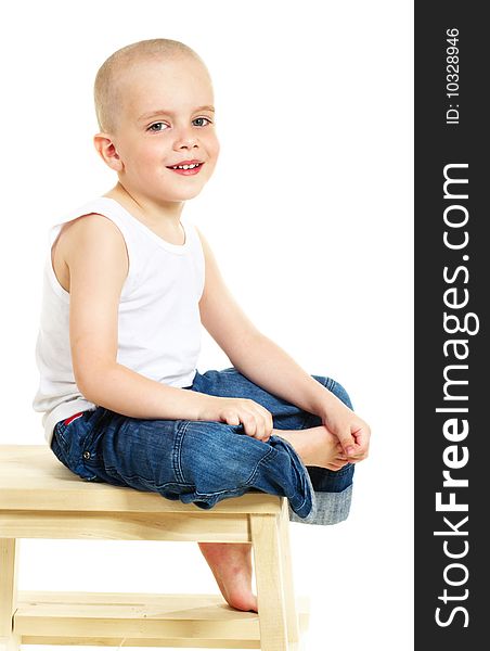 Laughing little boy sitting on stool
