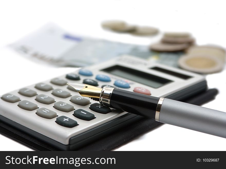 Business a still-life: calculator, fountain pen, money