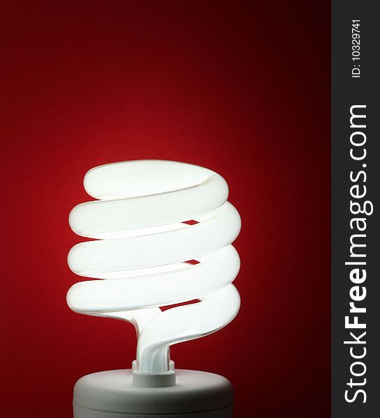 A light bulb on red background