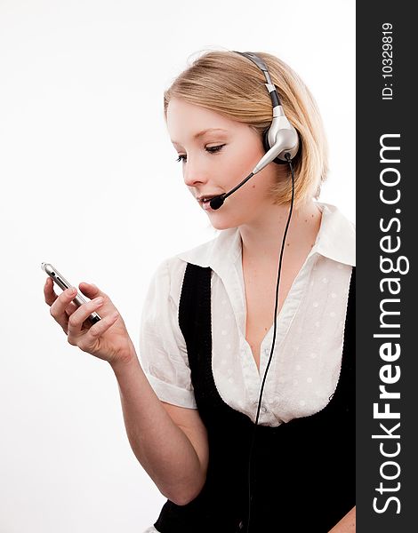 Young woman with headset and mobile phone at same time. Young woman with headset and mobile phone at same time