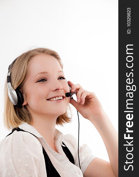 Young woman listens with smile - headset. Young woman listens with smile - headset