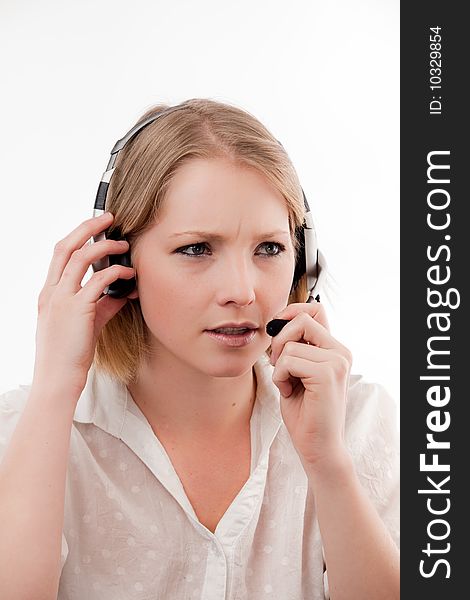 Confused young woman talks on a headset. Confused young woman talks on a headset