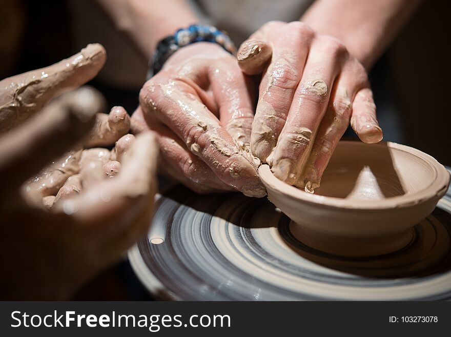 Child Learns To Make Pottery On The Potter`s Wheel