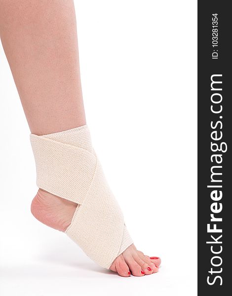 Women`s leg tied with an elastic bandage, ankle foot.