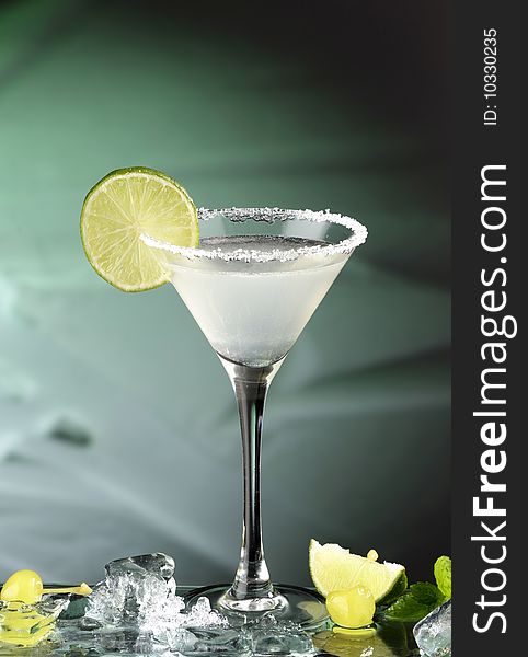 Glass of margarita cocktail with lemon
