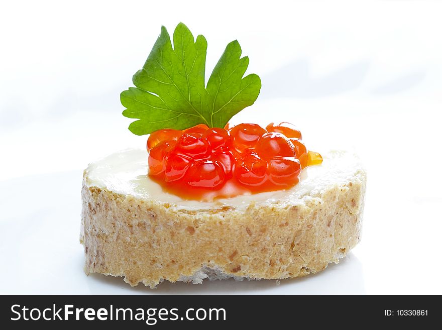 Red caviar with bread and butter over white plate. Red caviar with bread and butter over white plate