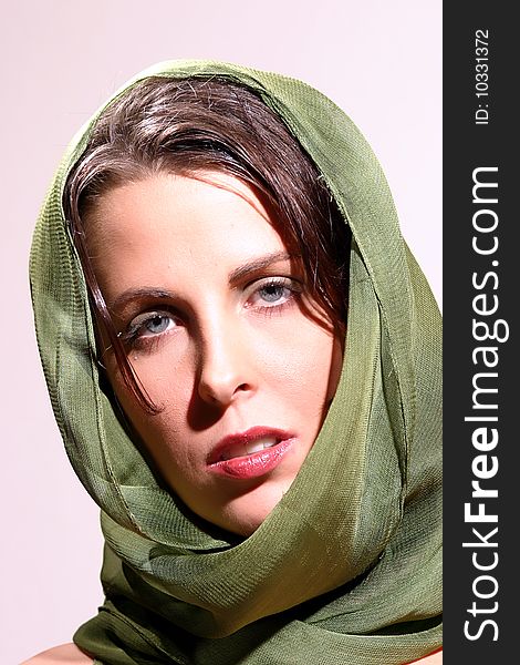 Attractive Brunette Woman poses in a with a green scarf. Attractive Brunette Woman poses in a with a green scarf