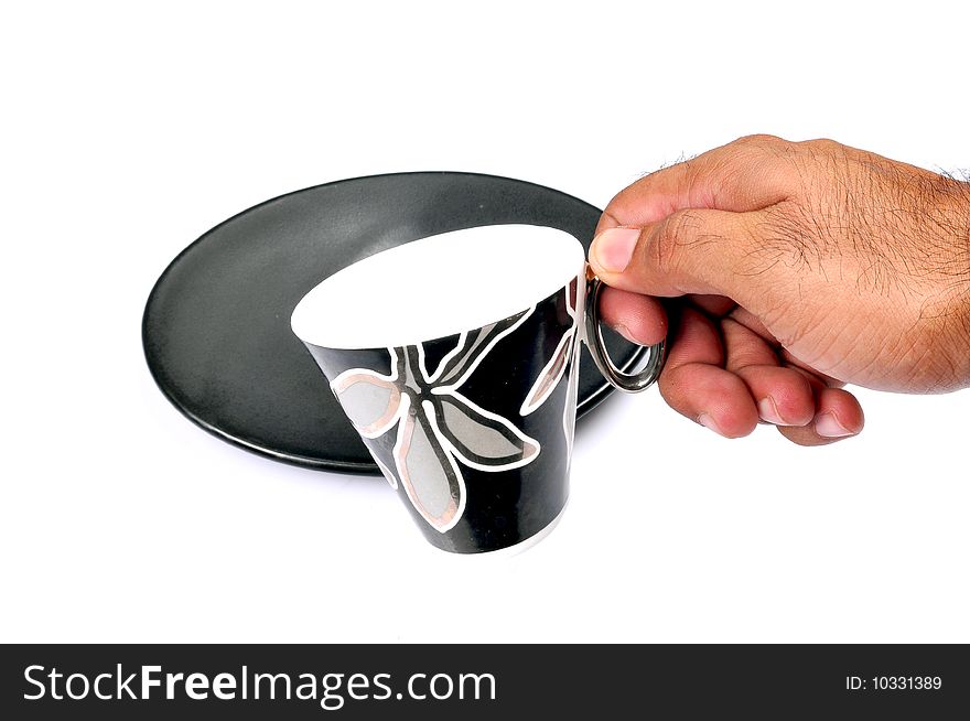 Male hand holding designer tea cup. Male hand holding designer tea cup.
