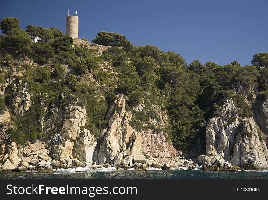 Cove on the Spanish Mediterranean cost, with castle's tower on top. Cove on the Spanish Mediterranean cost, with castle's tower on top.