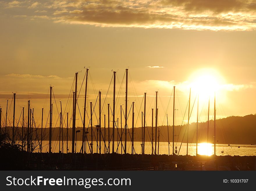 Masts of sailboats in the sunset south of Seattle, Washington. Masts of sailboats in the sunset south of Seattle, Washington