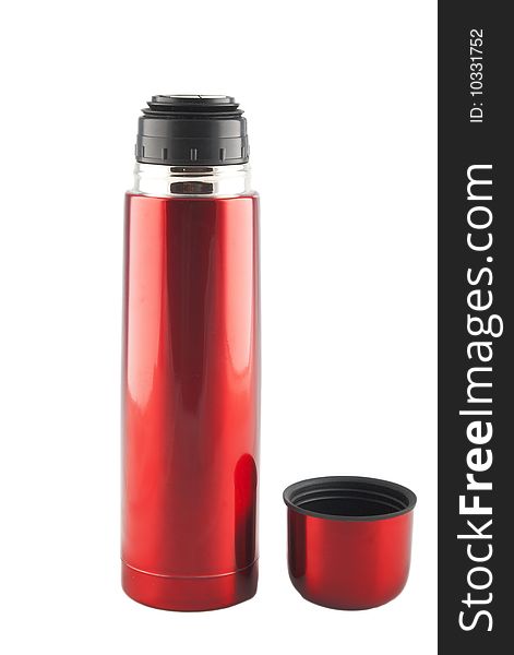 Red metal thermos  with cup nearby