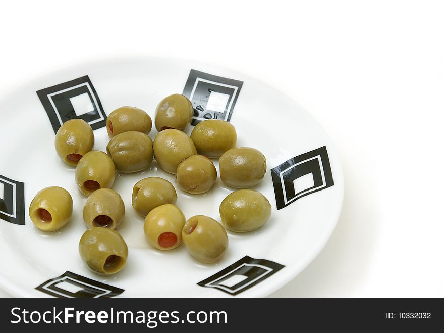 A bunch of green olives on a plate.
