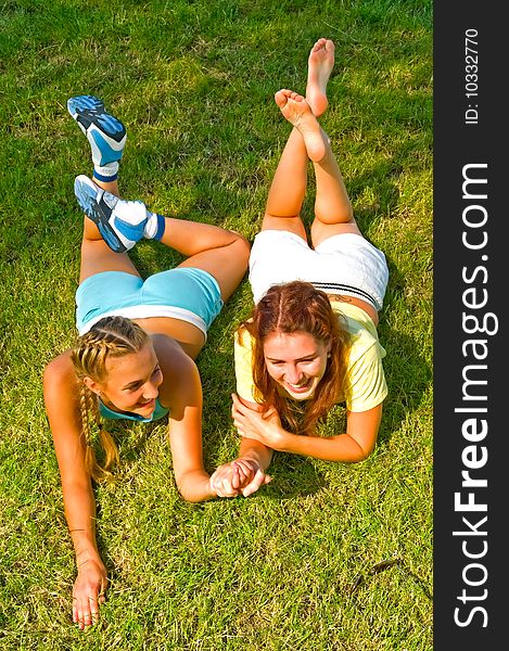 Smiling girls laying on the grass