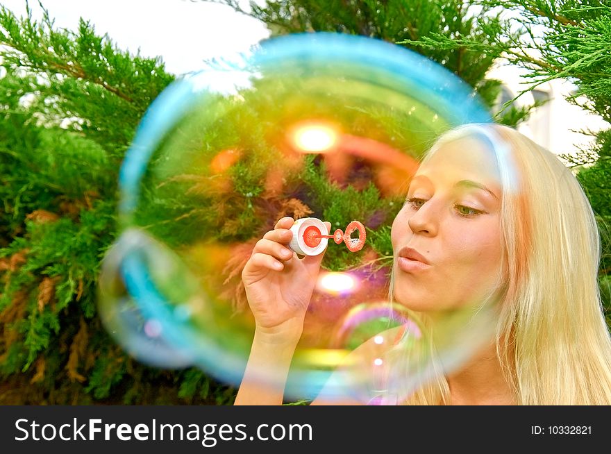 Young smiling woman blow bubbles. Young smiling woman blow bubbles
