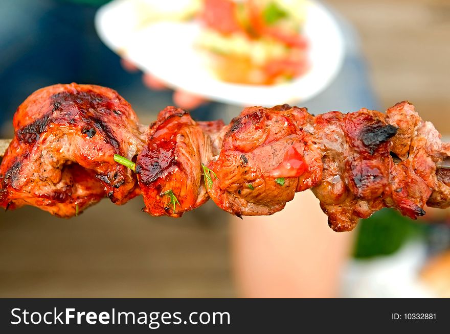 Shashlik roasted meat on spit close-up. Shashlik roasted meat on spit close-up