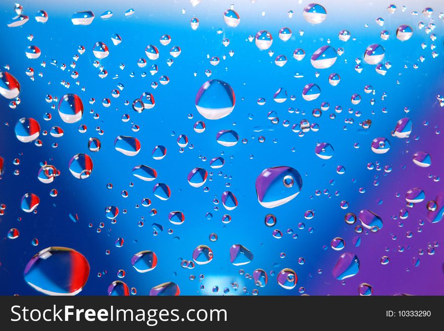 Coloured drops of water on the coloured background