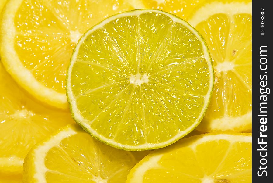 Lime round cut segment between lemons. Lime round cut segment between lemons