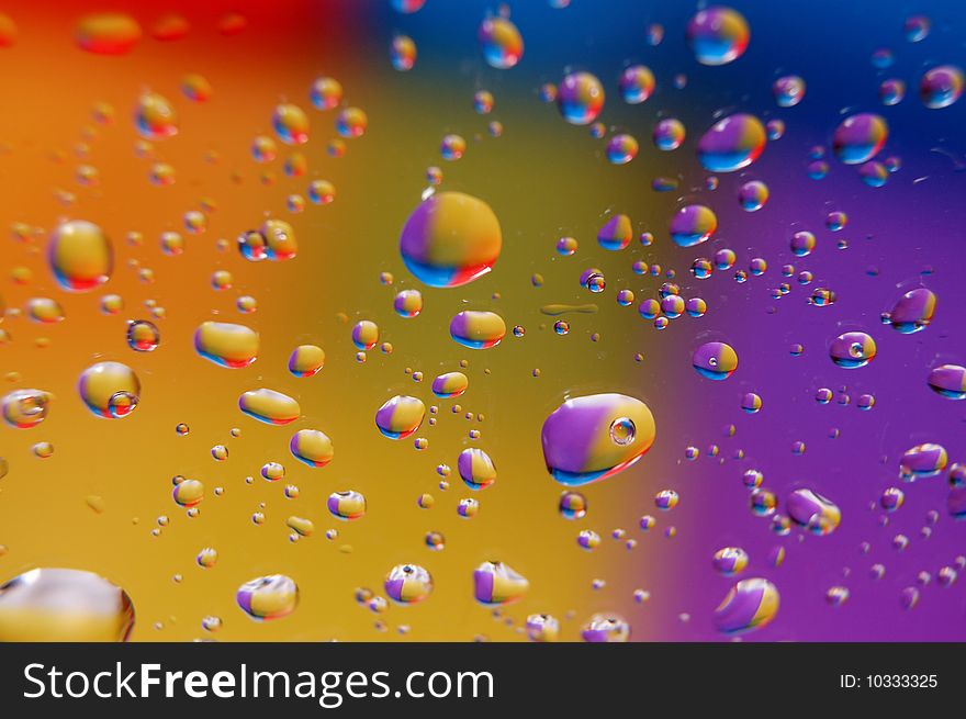 Coloured drops of water on the coloured background