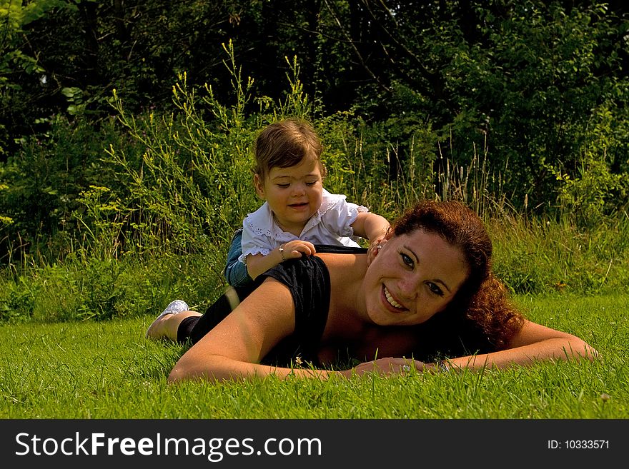 Mother And Daughter On Grass