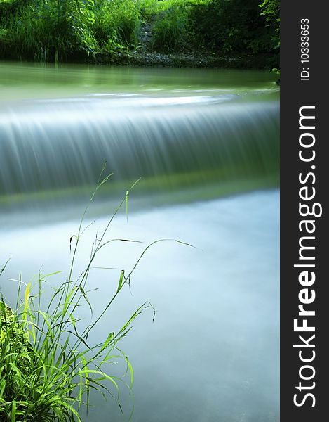 Small waterfall on a sunny summer day. Small waterfall on a sunny summer day