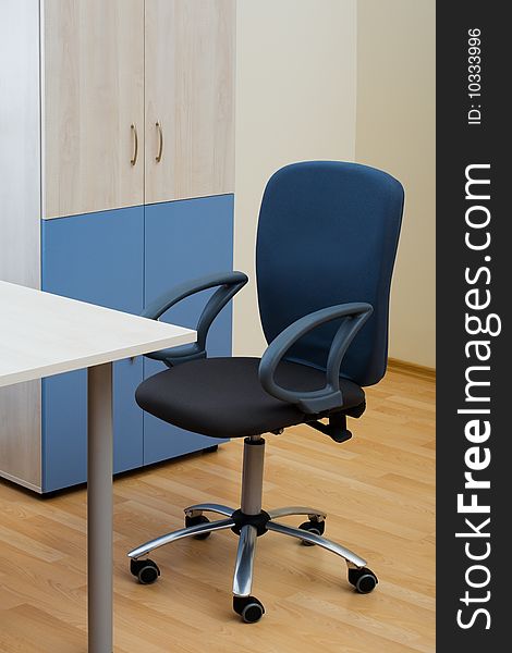 Table, chairs and bookcase at modern office