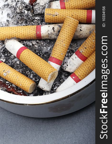 Close-up of cigarette butts in ashtray