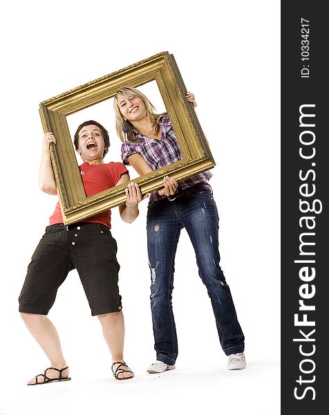 Young women posing with wooden frame. Young women posing with wooden frame