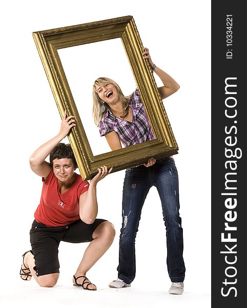 Young women posing with wooden frame. Young women posing with wooden frame