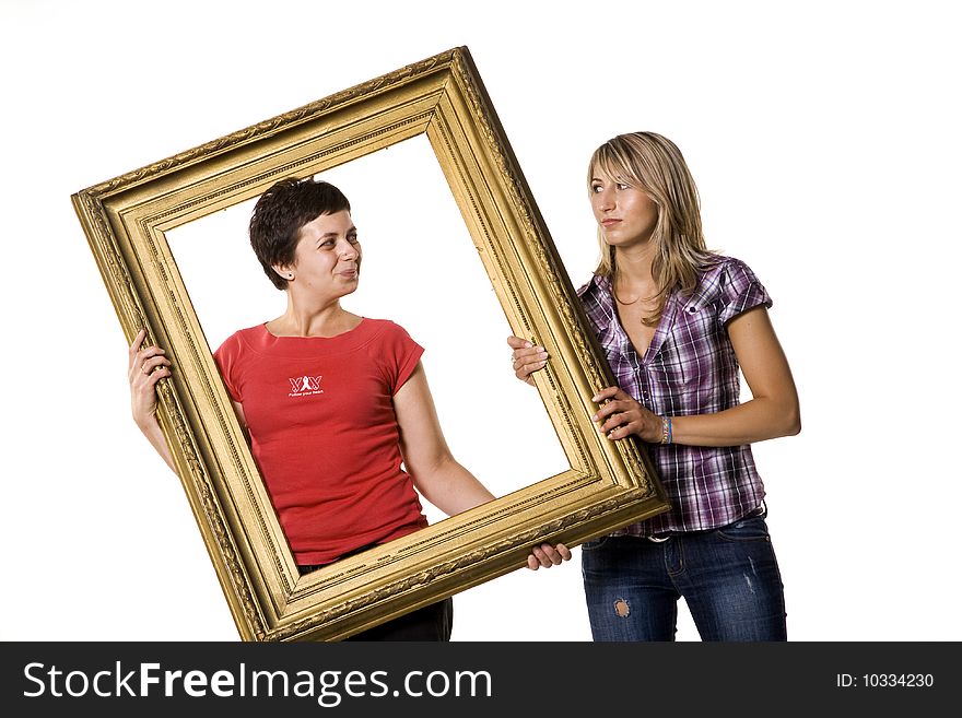 Young women holding wooden frame