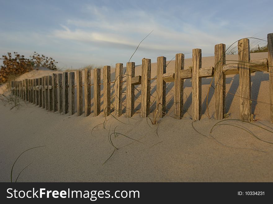 Strips of wood on a beach buried on sand. Strips of wood on a beach buried on sand