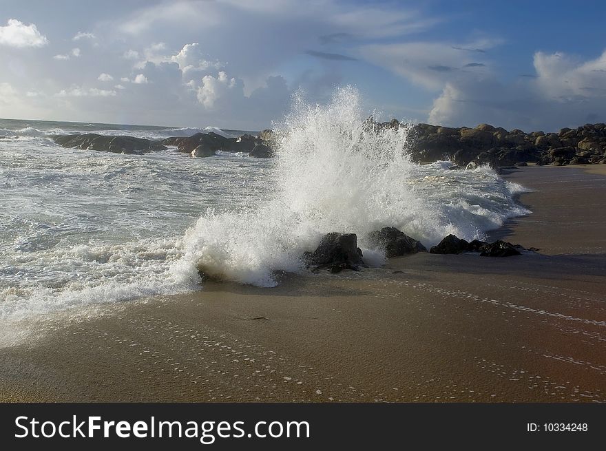 A beautiful beach with waves breaking on the rocks