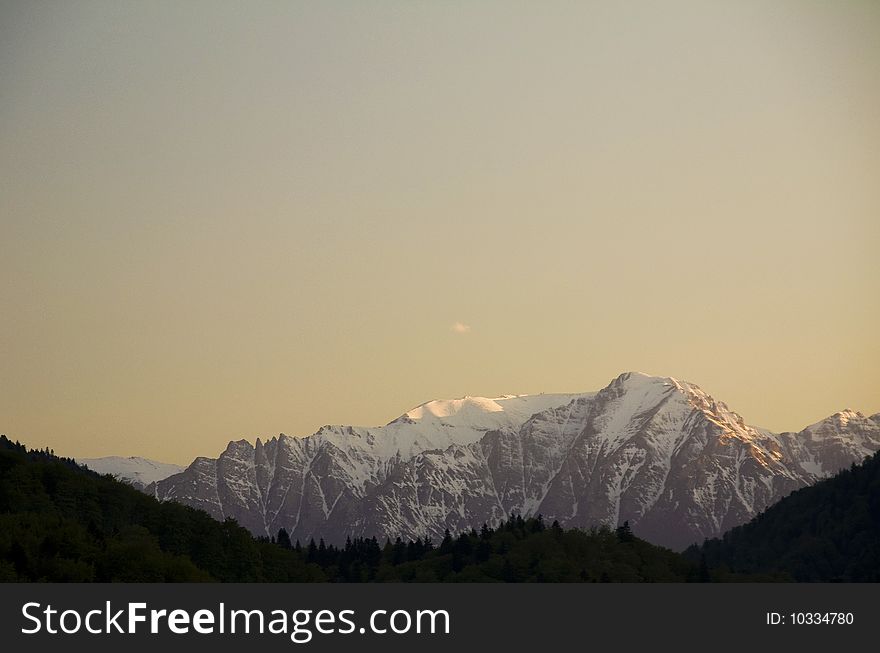 Snow peaks in the sunset, Carpathian mountains, Romania.