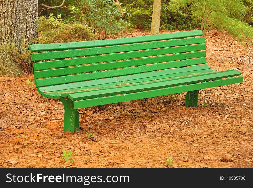 A green garden bench in a botanical garden