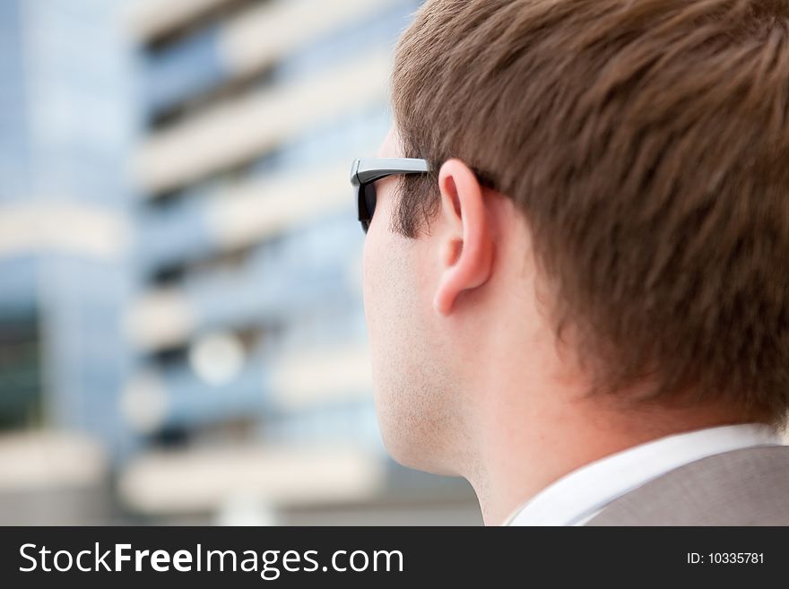 Businessman with sunglasses outdoor the office
