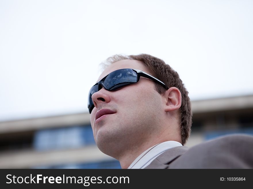 Businessman with sunglasses outdoor the office