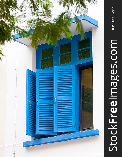 Blue windows on the facade of buildings in Singapore, retained for decorative purposes